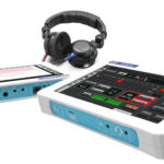 Image of the audiometer device, it is like a tablet with headphones attached.